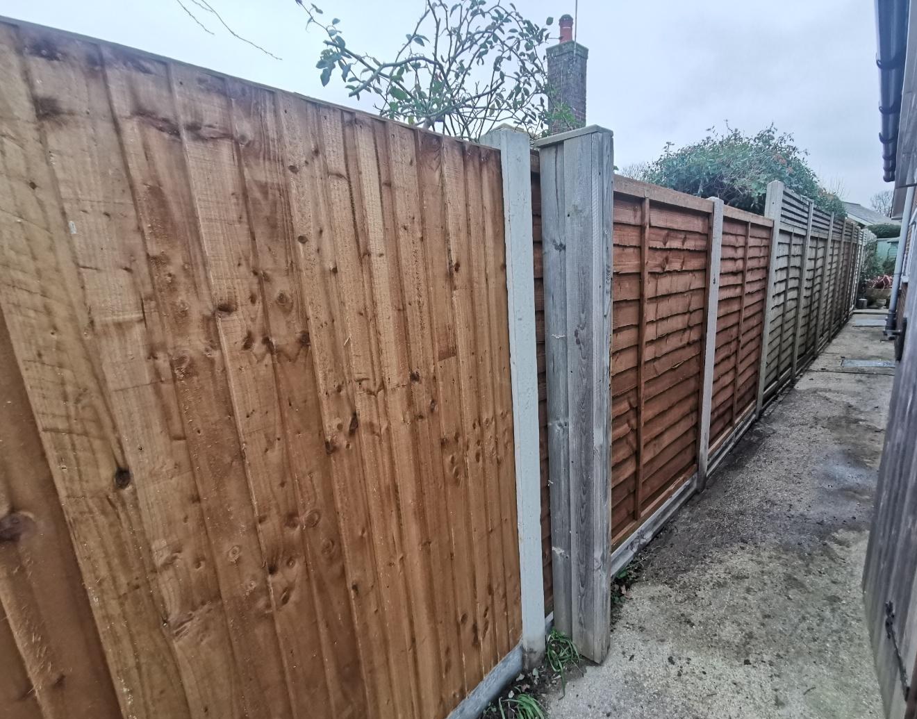 Close-board run down the side alley, concrete posts